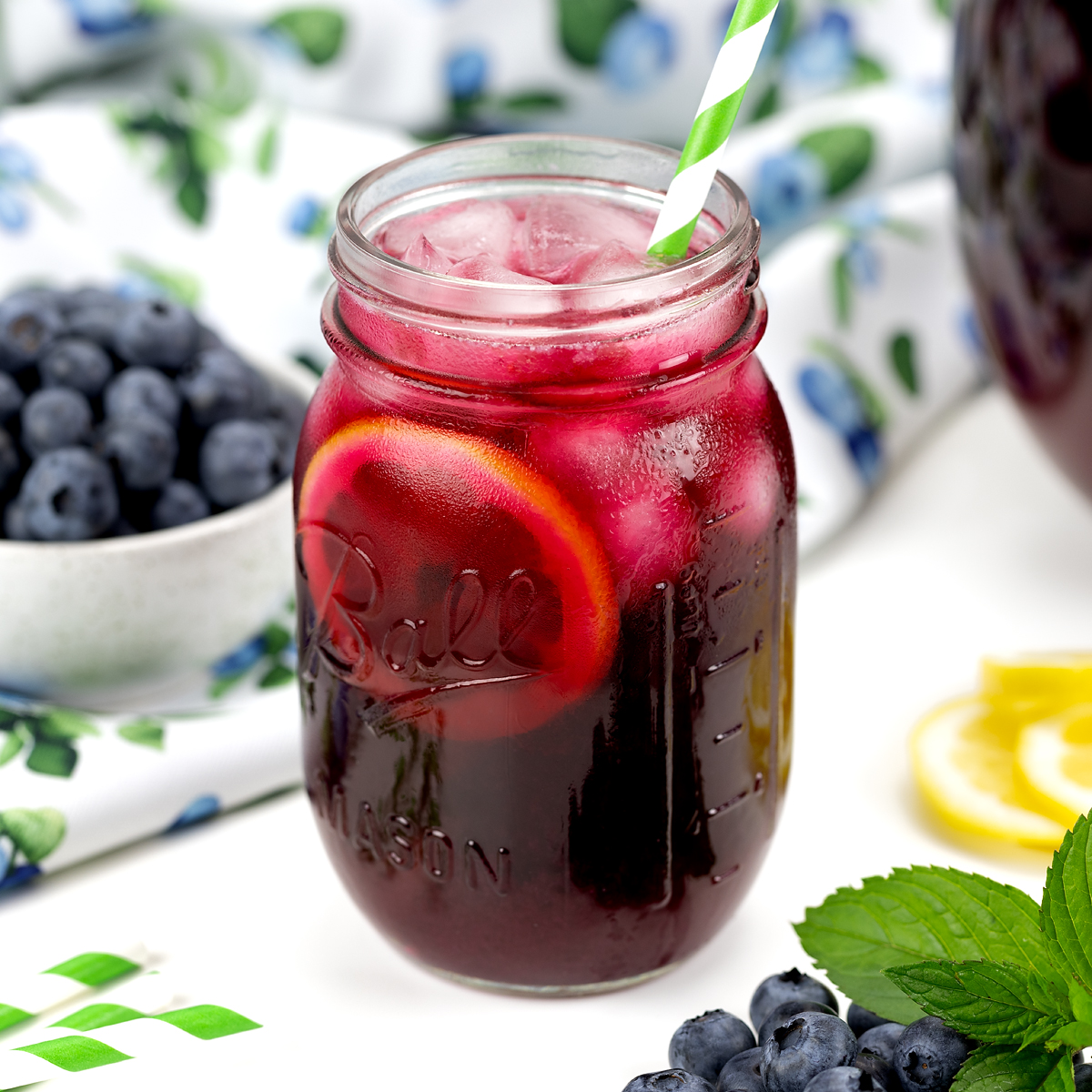 Cold blueberry lemonade in a mason jar.