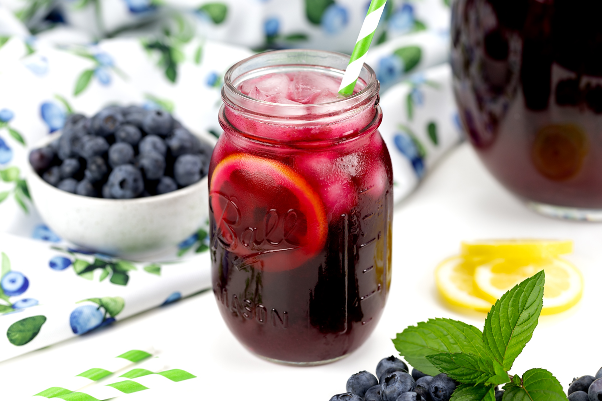 Blueberry lemonade in a mason jar ready to drink.