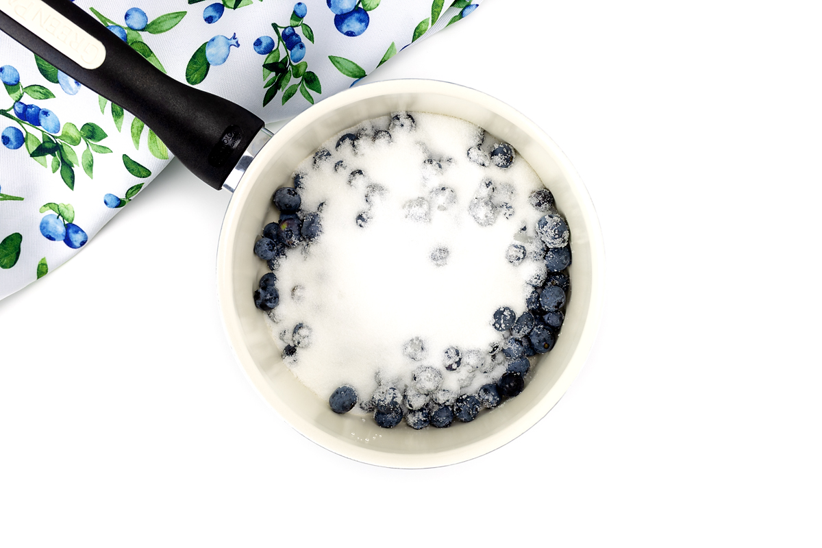 Blueberries and sugar mixed together to make syrup.