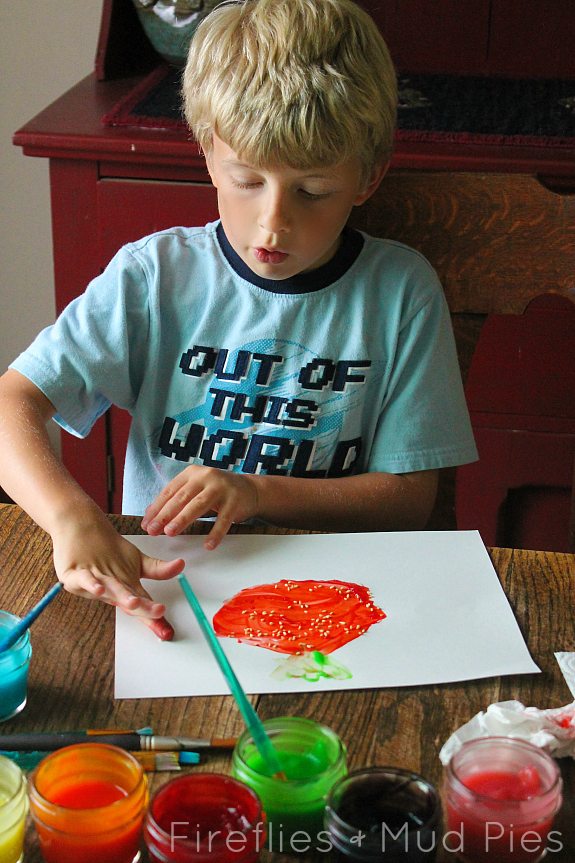 Painting a strawberry with strawberry scented fingerpaint! - Fireflies and Mud Pies