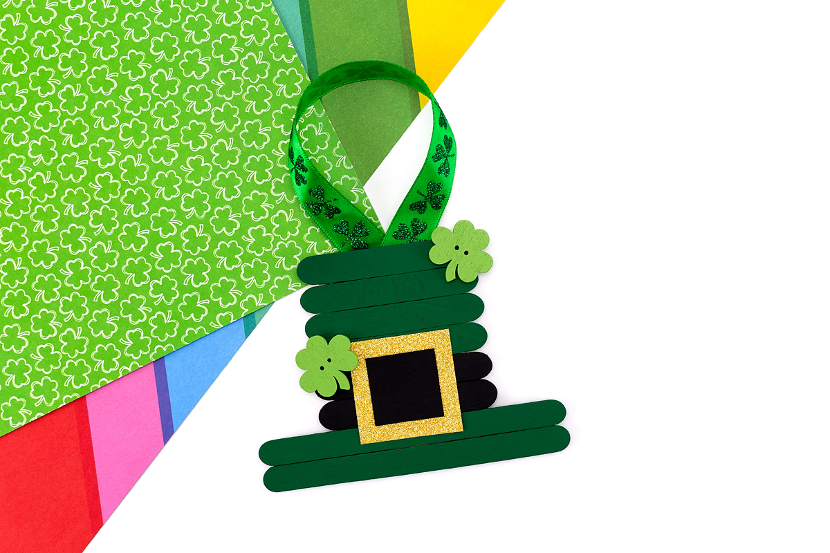 Finished popsicle stick leprechaun ornament on a table. 