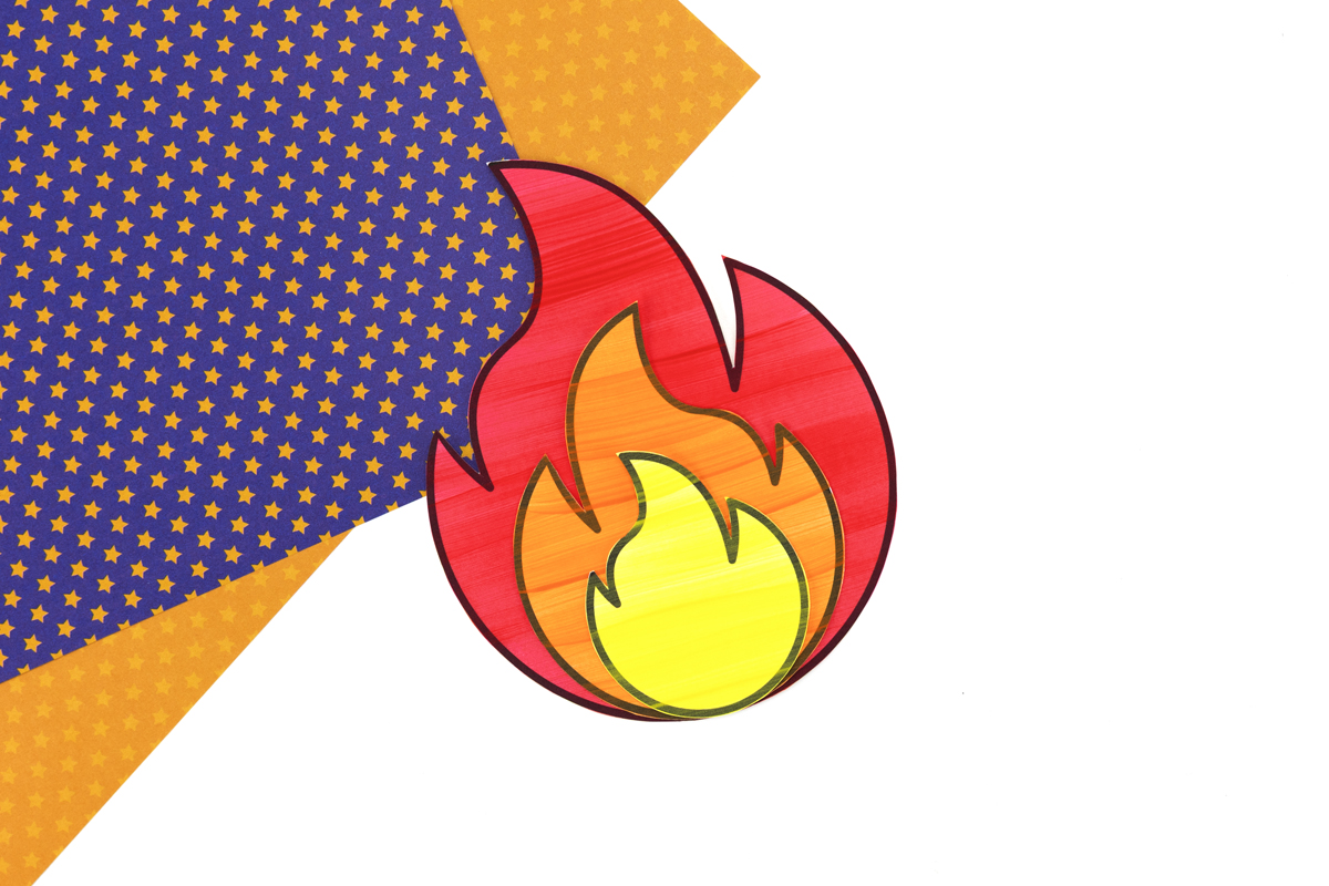 Layered red, orange, and yellow paper flames glued together, ready to attach to the torch.