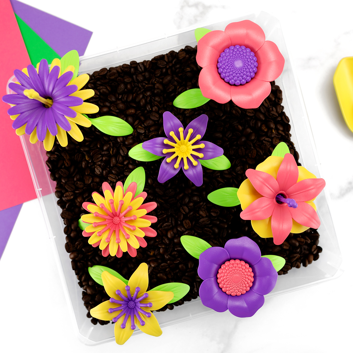 Garden Sensory Bin Garden sensory bin with plastic flowers.