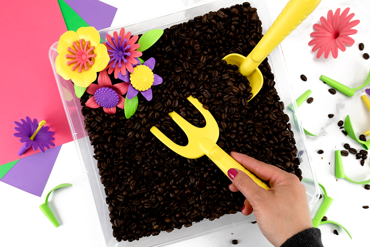 Digging in Garden Sensory Bin Raking in a garden sensory bin.