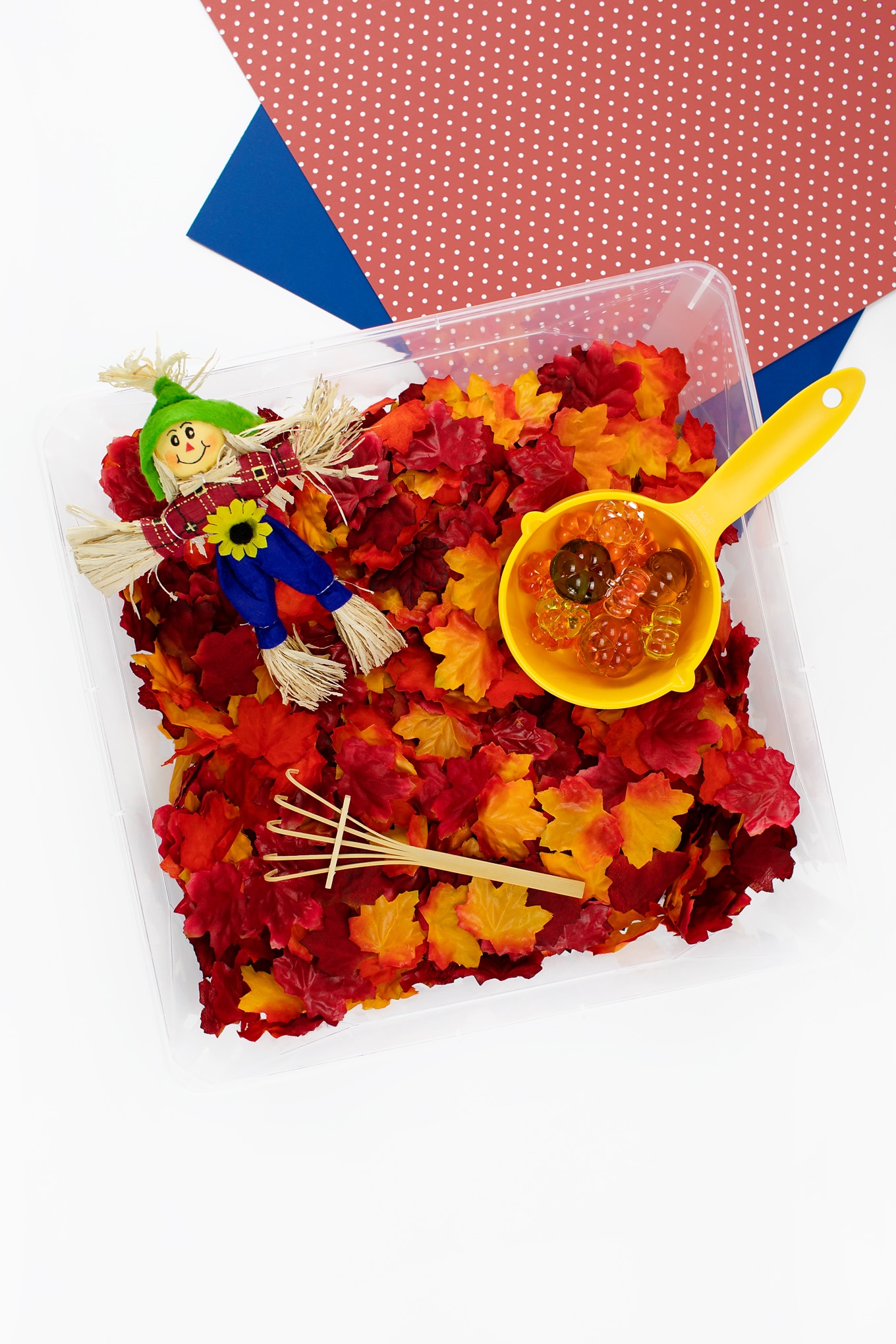 Fall Sensory Bin with Leaves and a Scarecrow