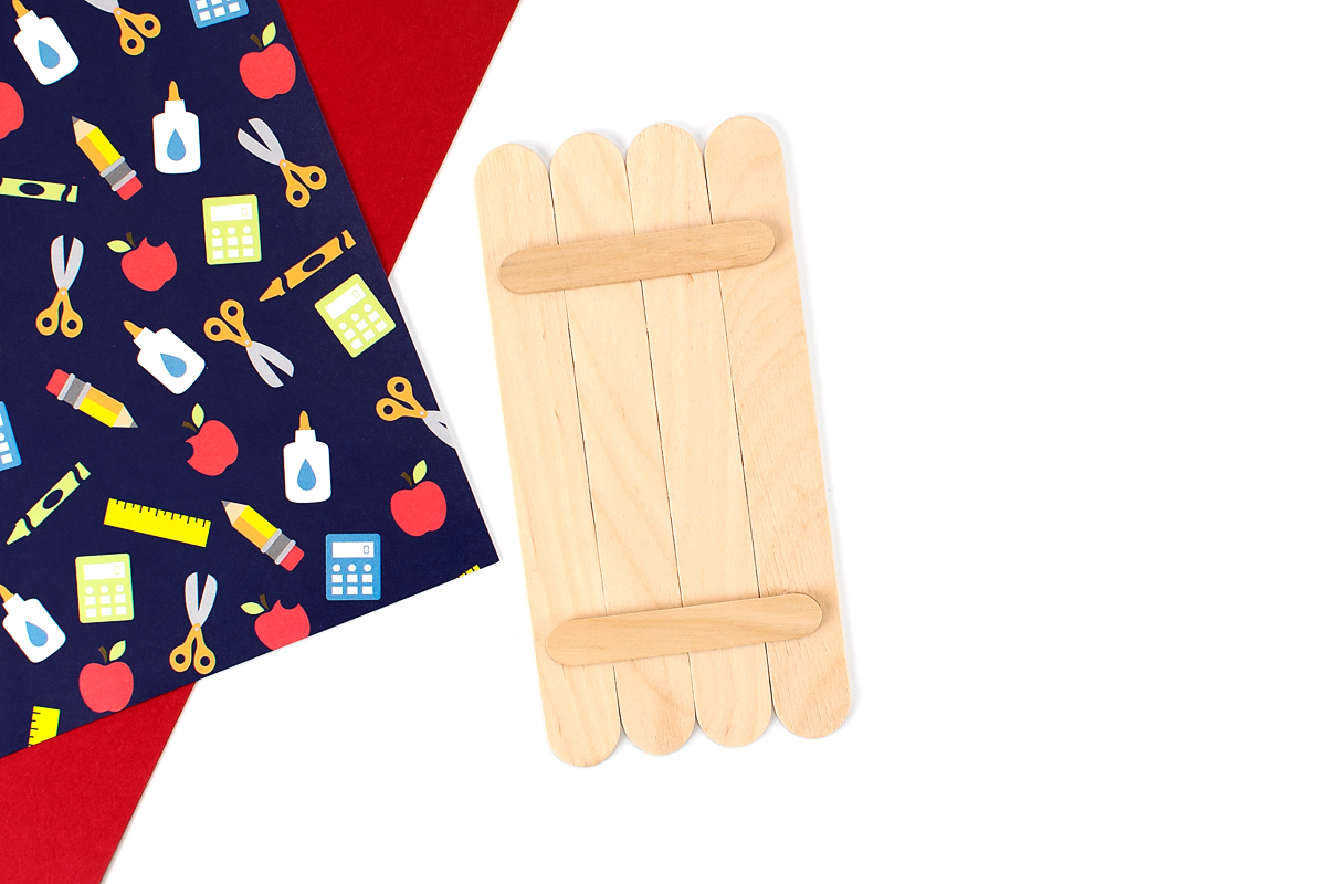 Wide craft sticks lined up in a row.