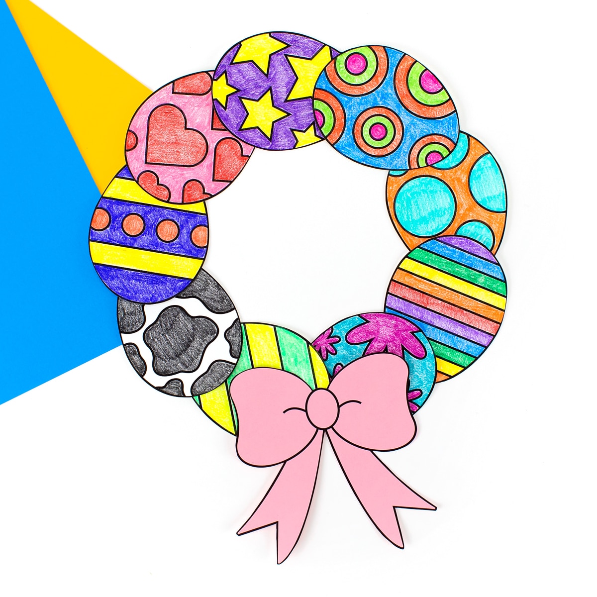 Paper Easter egg treat on blue and yellow paper.