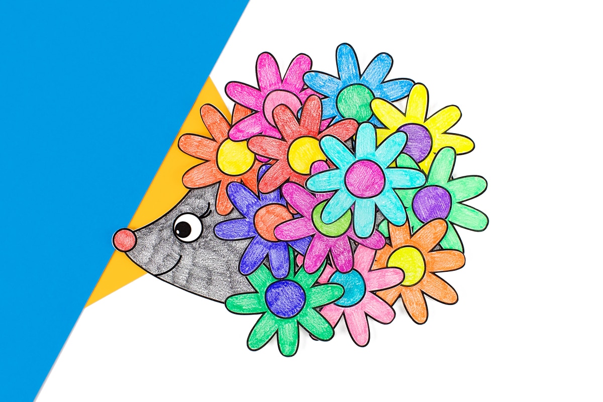 Finished hedgehog card on blue and yellow paper.