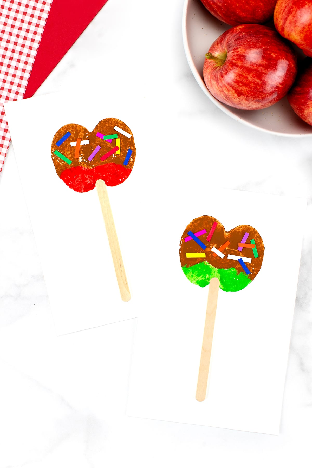 Photo of a colorful caramel apple craft with red and green accents, showcasing a delightful fall-themed creative project for children.