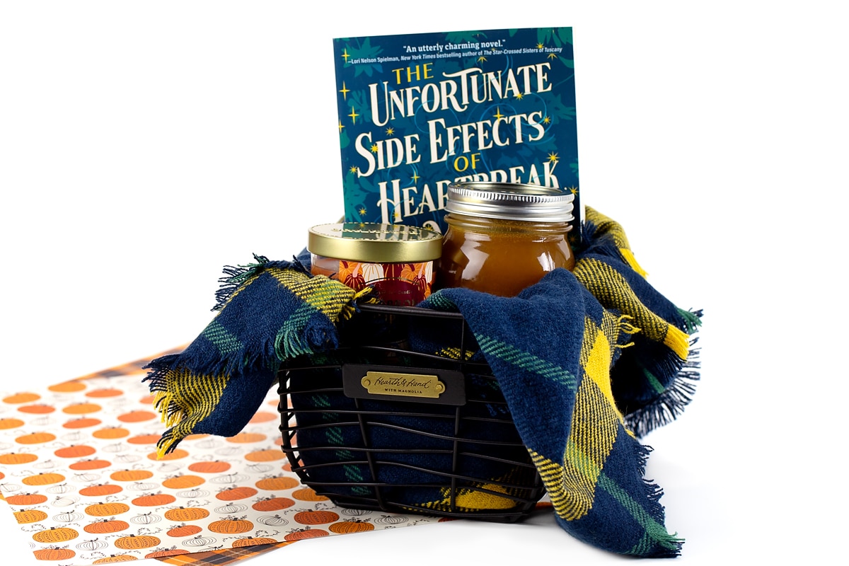 A Boo Basket filled with a book, a candle, and caramel.