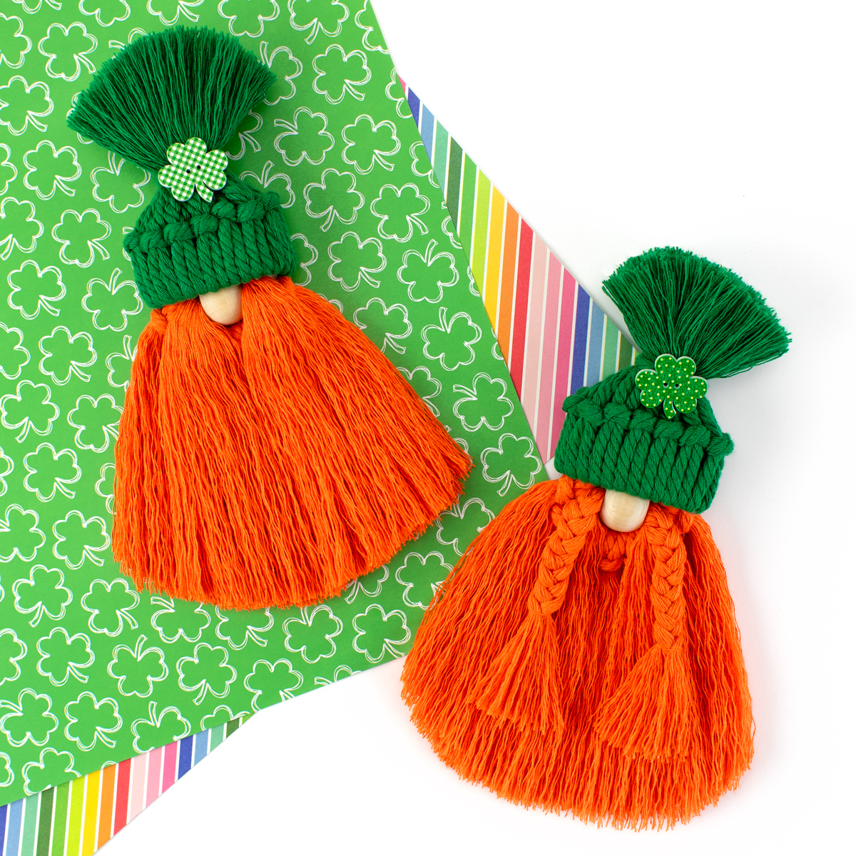 Two macrame gnomes on St. Patrick's Day themed paper.