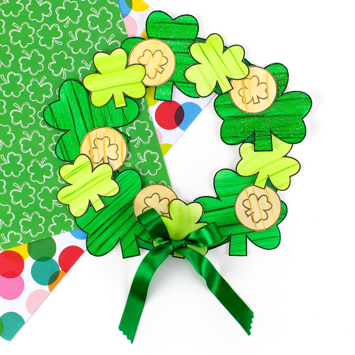 Shamrock craft for kids on colorful scrapbook paper.