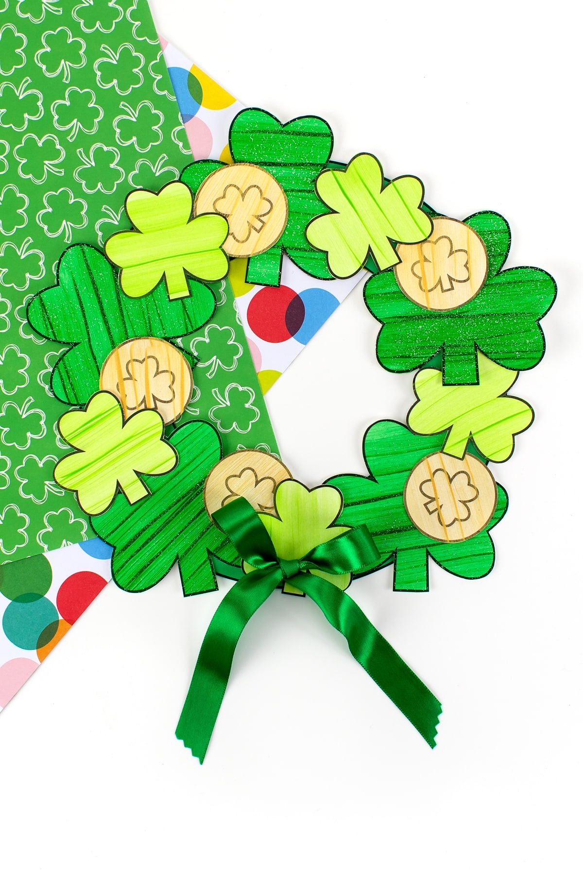 Finished St. Patrick's Day Shamrock Wreath on colored scrapbook paper.
