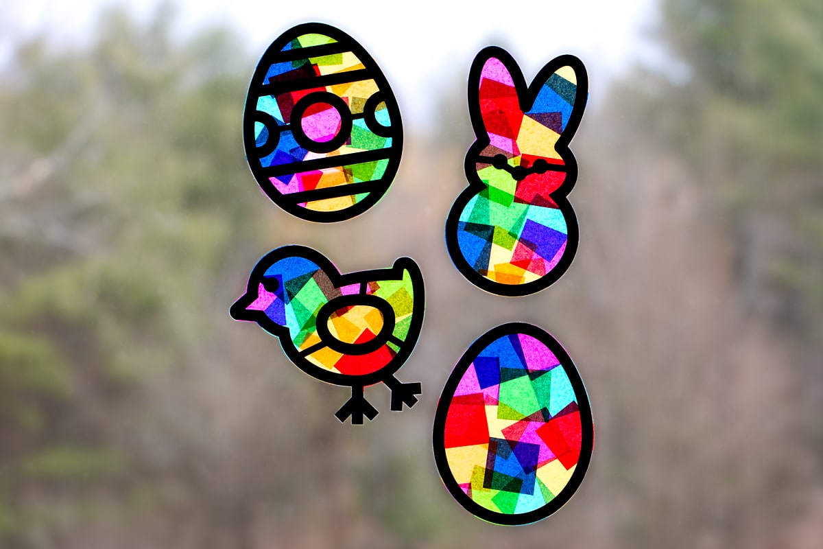 Four Easter suncatchers hanging in a window.