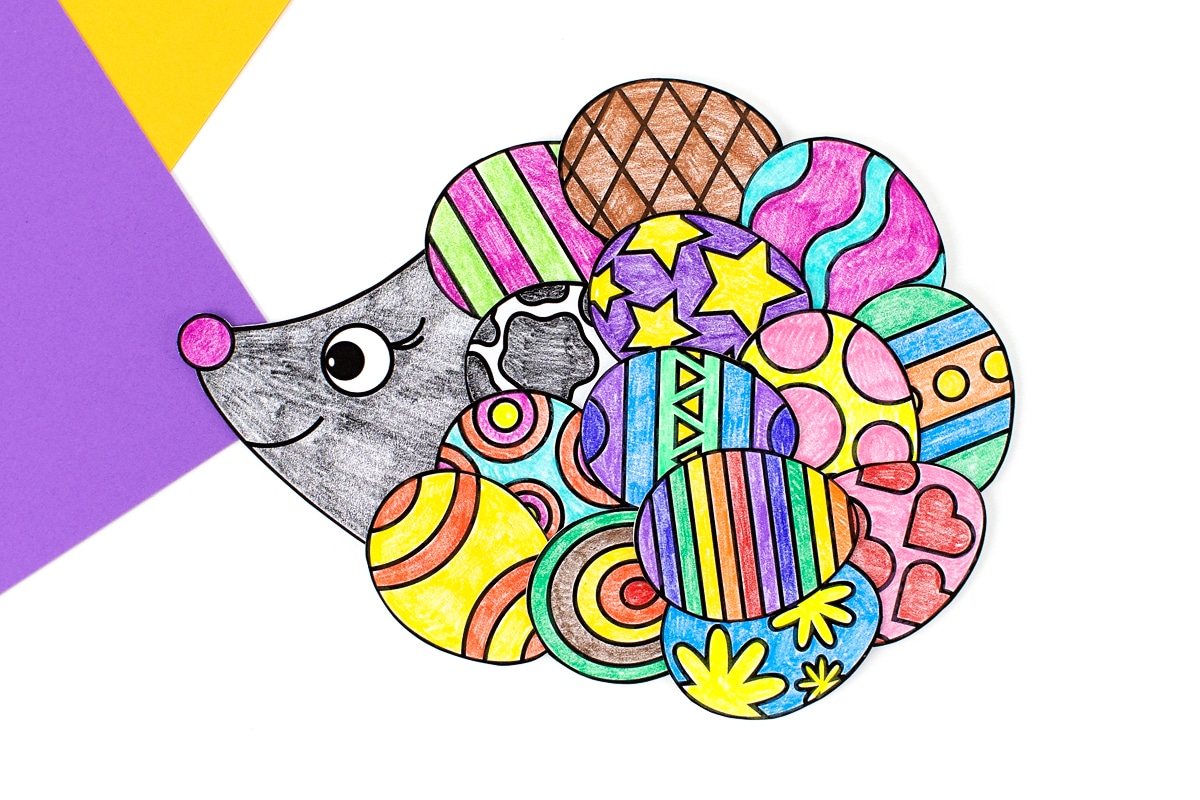 Easter hedgehog craft for kids on purple and yellow paper.