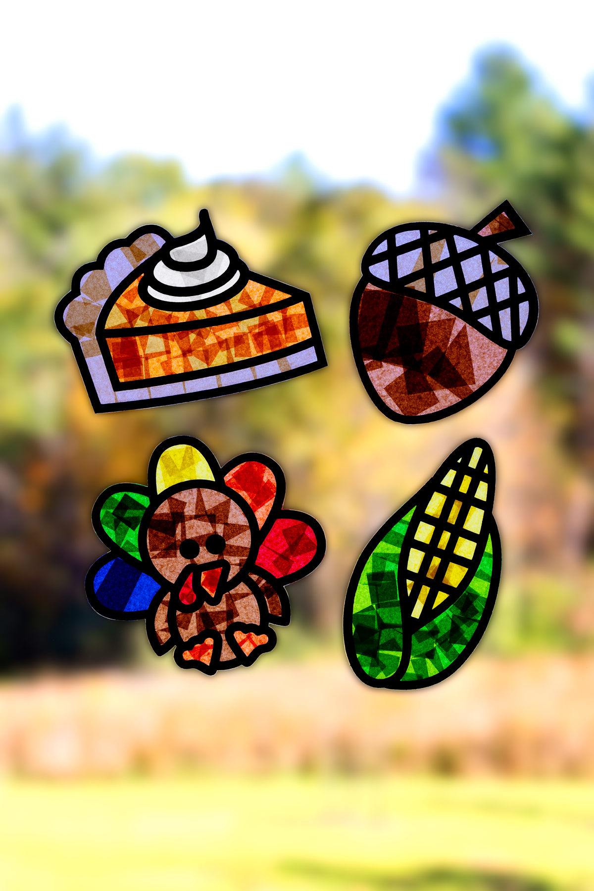 Thanksgiving suncatchers for kids hanging on a window.