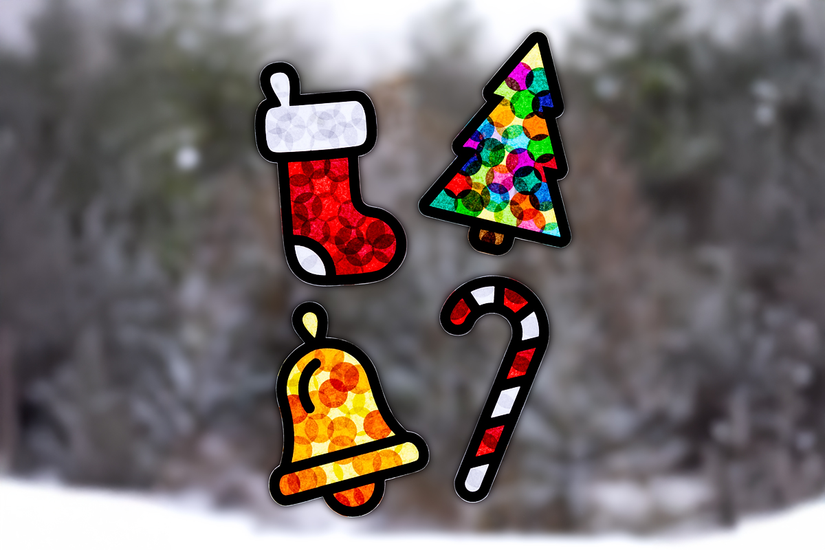 Finished Christmas suncatchers hanging on a window.