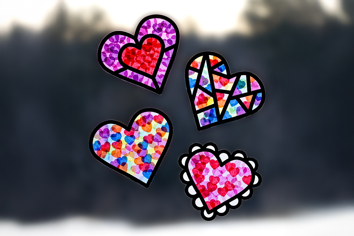 Four Valentine Suncatchers hanging in a window.