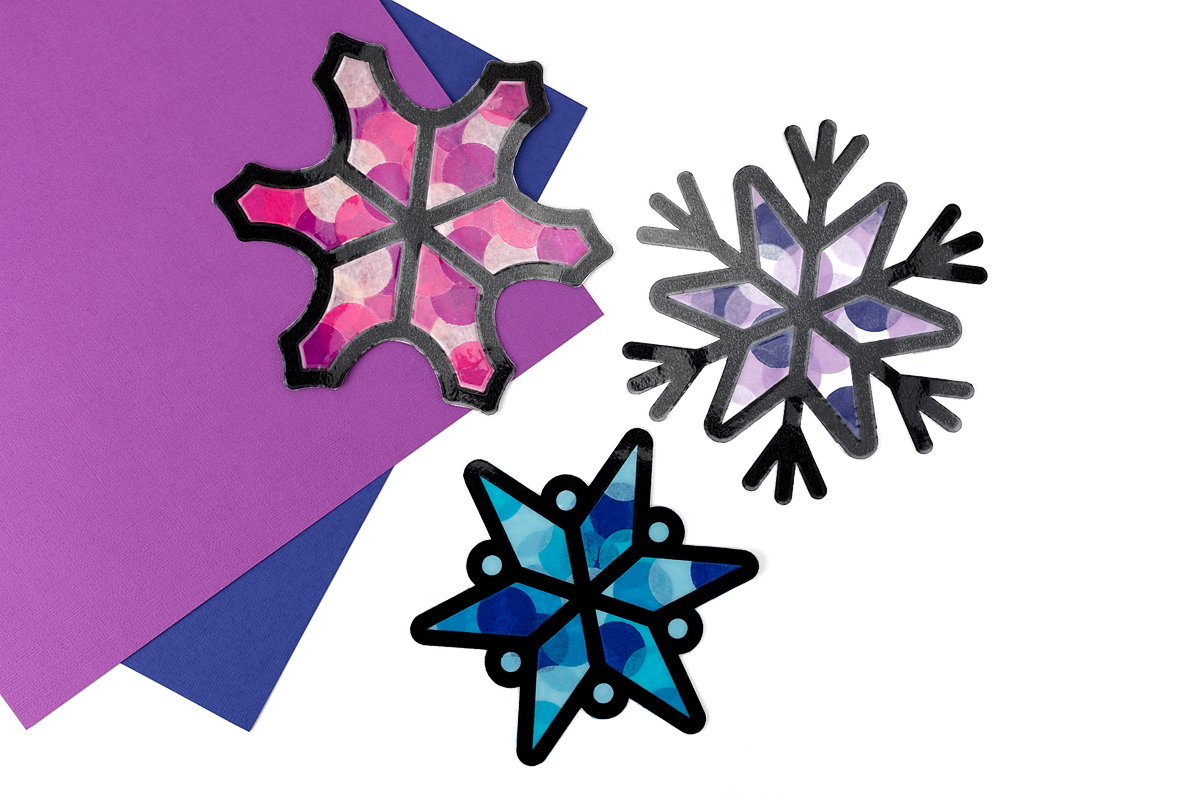 Three finished snowflake suncatchers.
