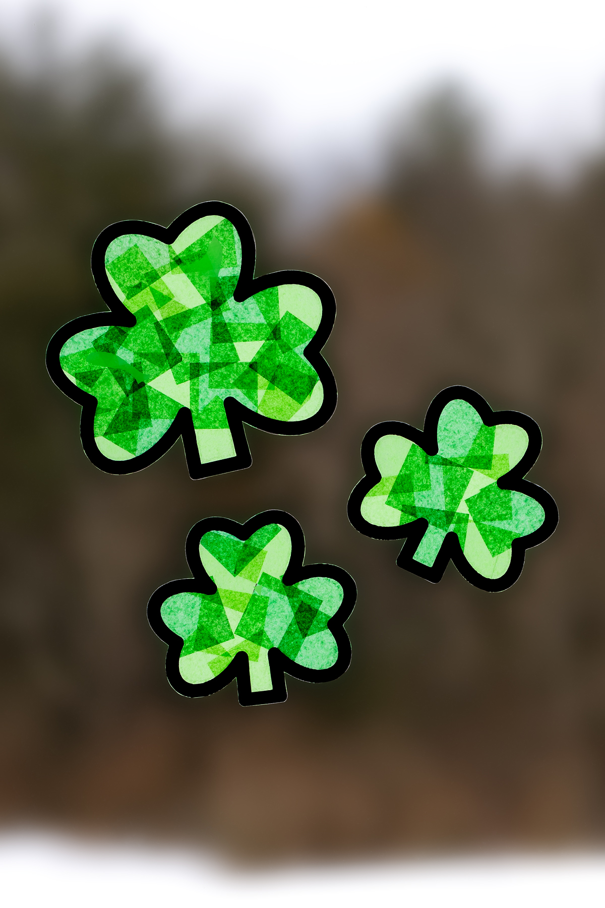 Shamrock suncatcher hanging in a window.