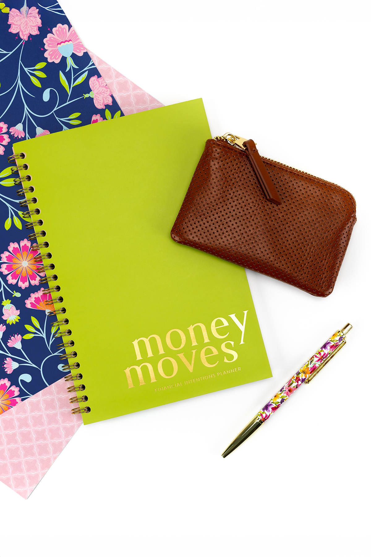 Financial planner, wallet, and pen on a table.
