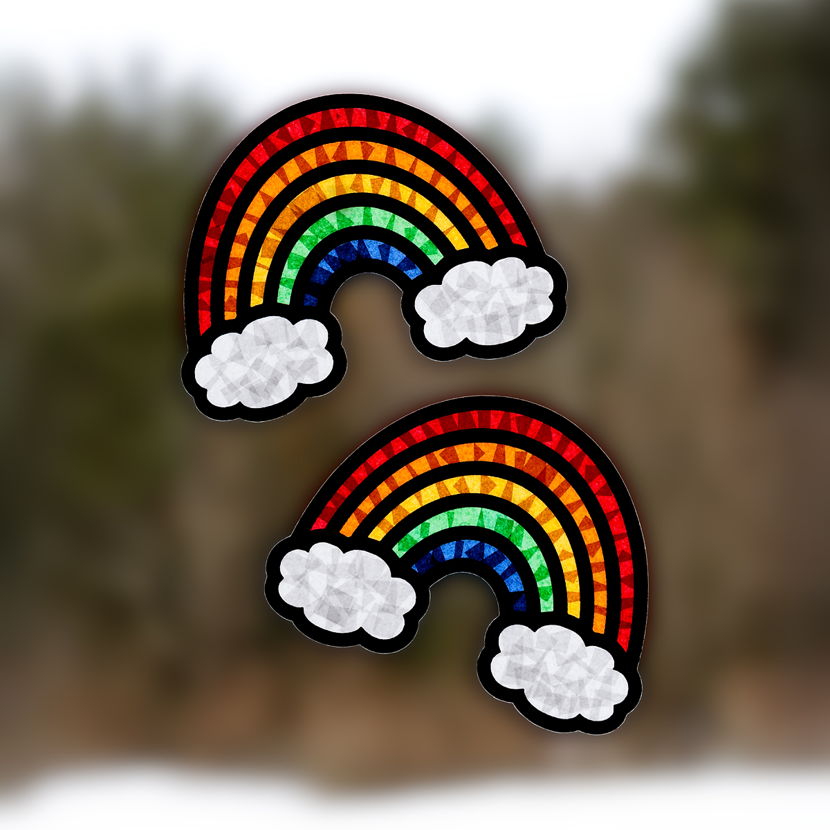 Two rainbow suncatchers hanging in a window.