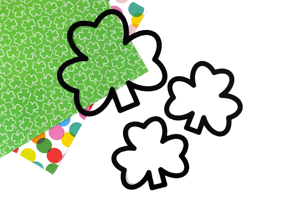 Shamrock suncatcher templates on a table.