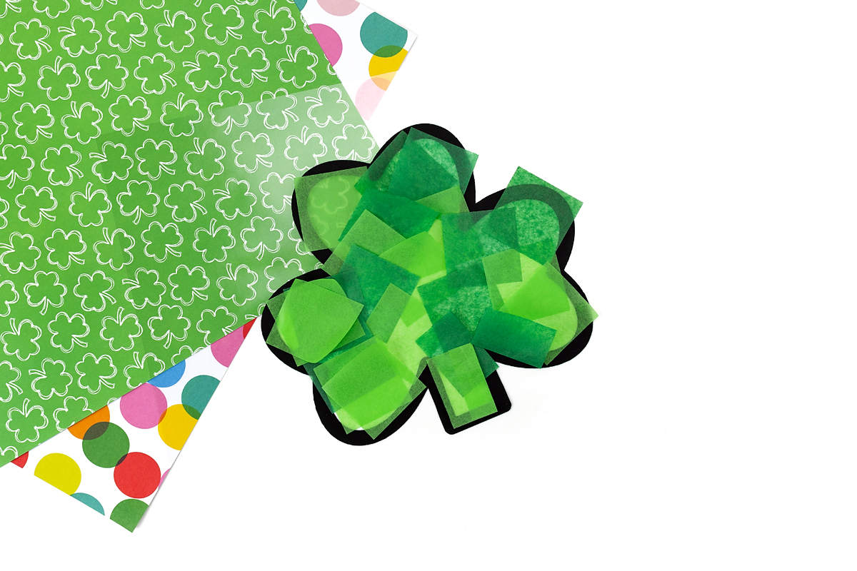 Tissue paper stuck on contact paper to make a shamrock suncatcher.