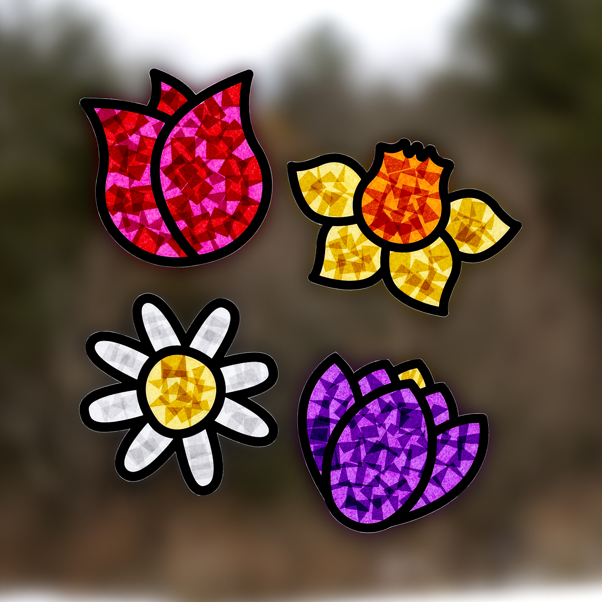 Four flower suncatchers hanging on a window.