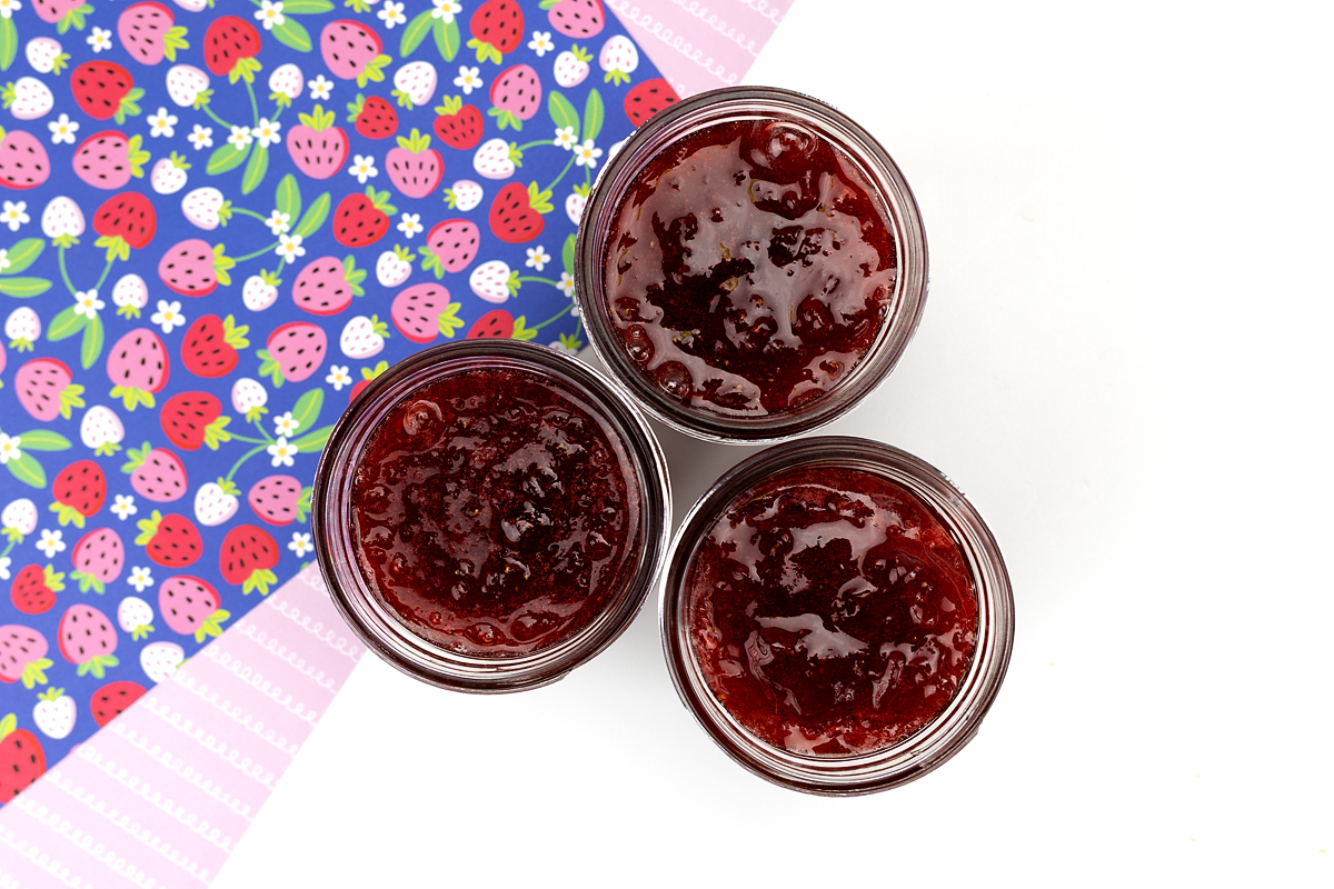 Three jars of strawberry jam.
