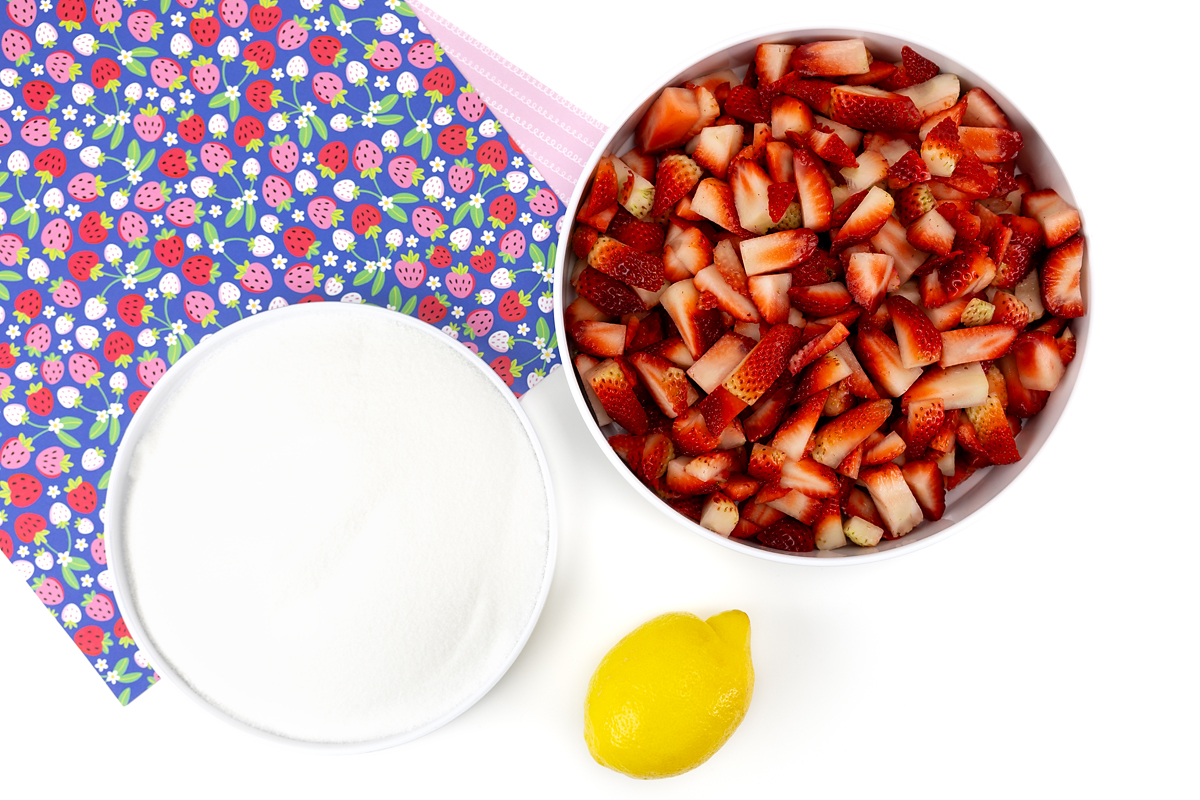 Photo of sugar, strawberries, and a lemon.