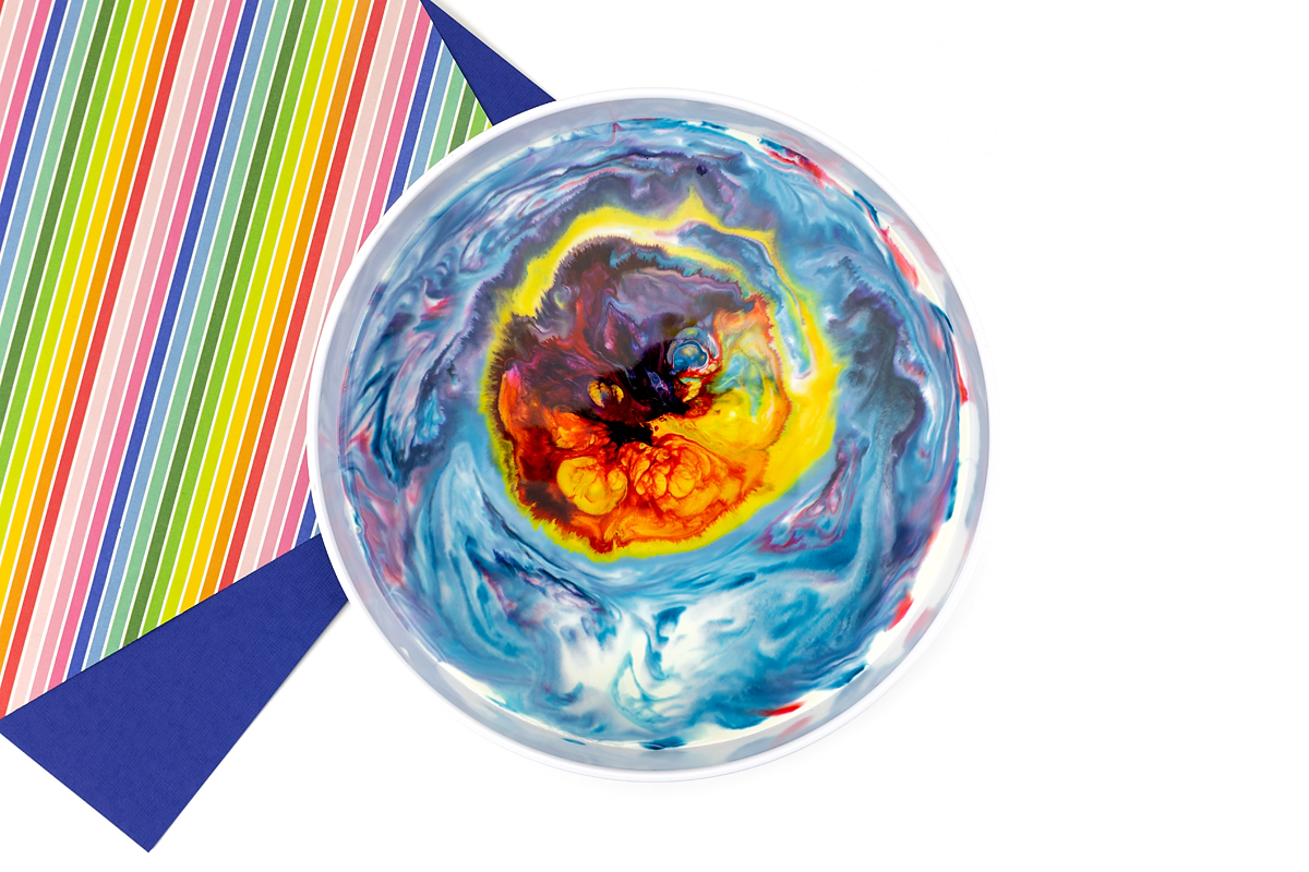 Blue, yellow, and red magic milk experiment.