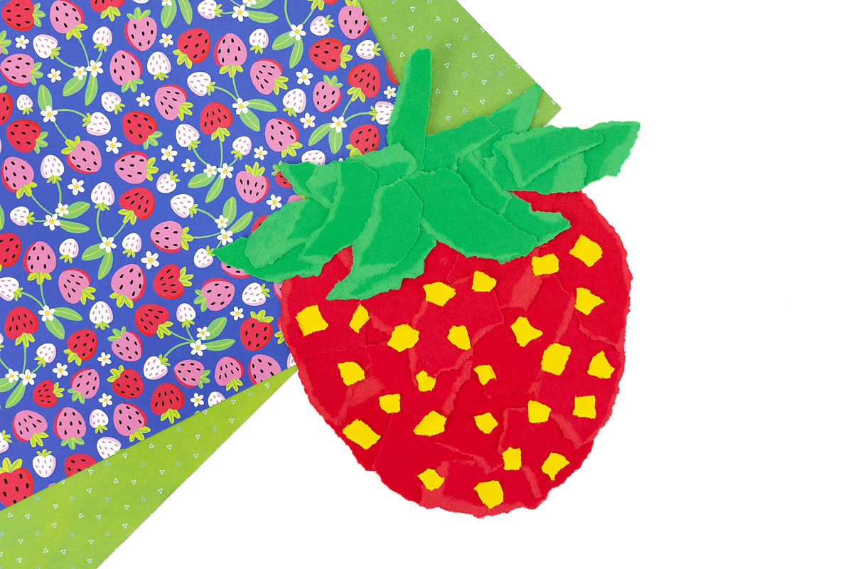 Torn paper pieces used to create a strawberry shape.