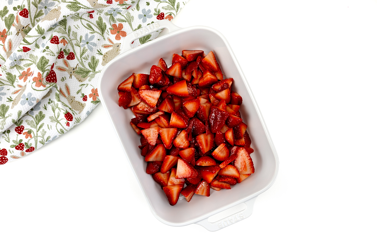 Strawberries resting in a baking dish.
