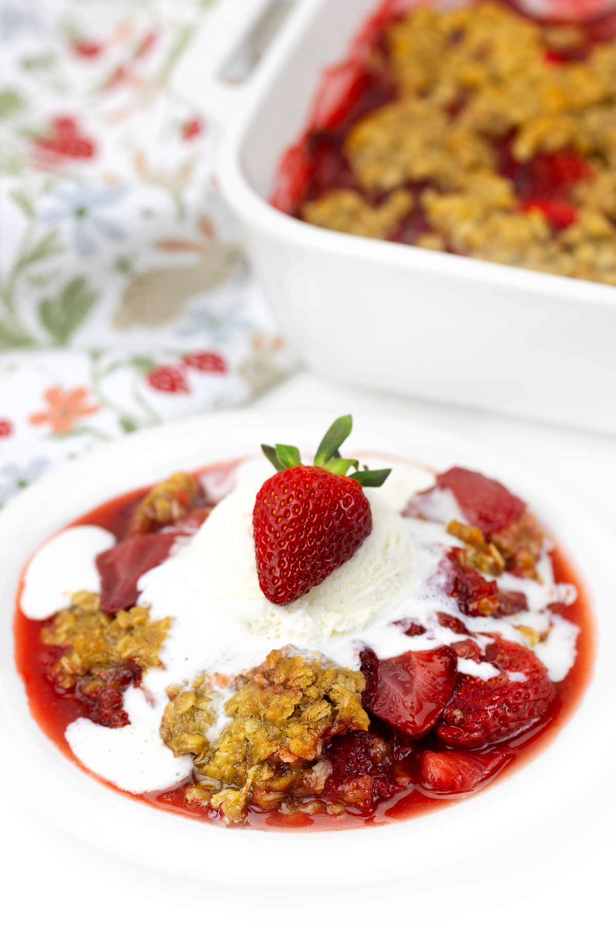 Baked strawberry crisp with vanilla ice cream.