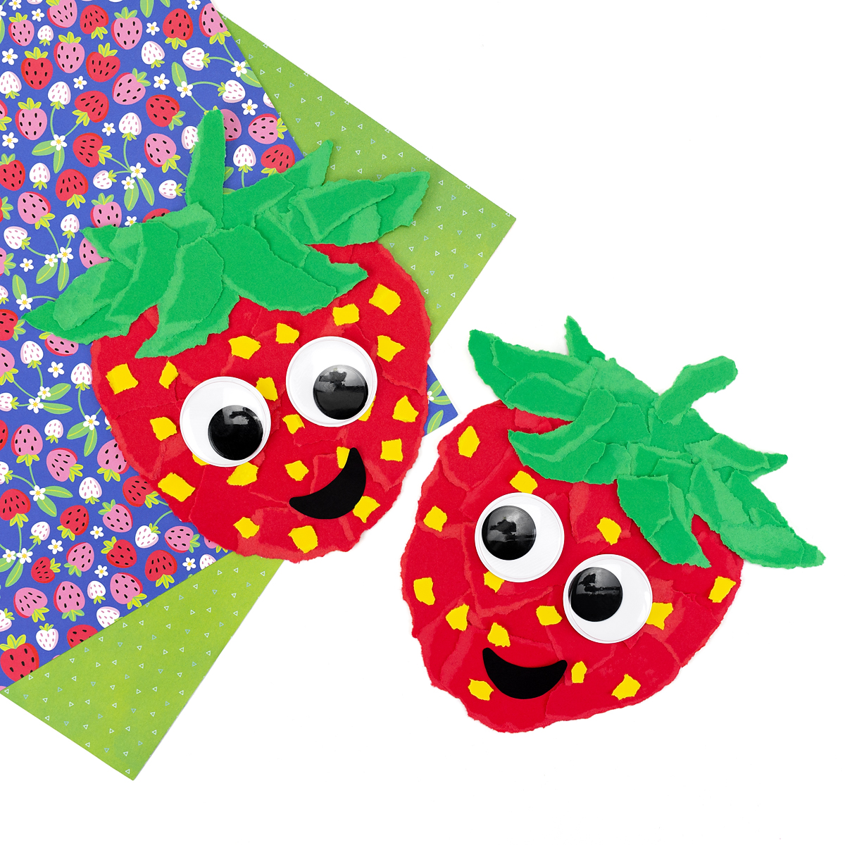 Two Torn Paper Strawberries on a white backdrop.