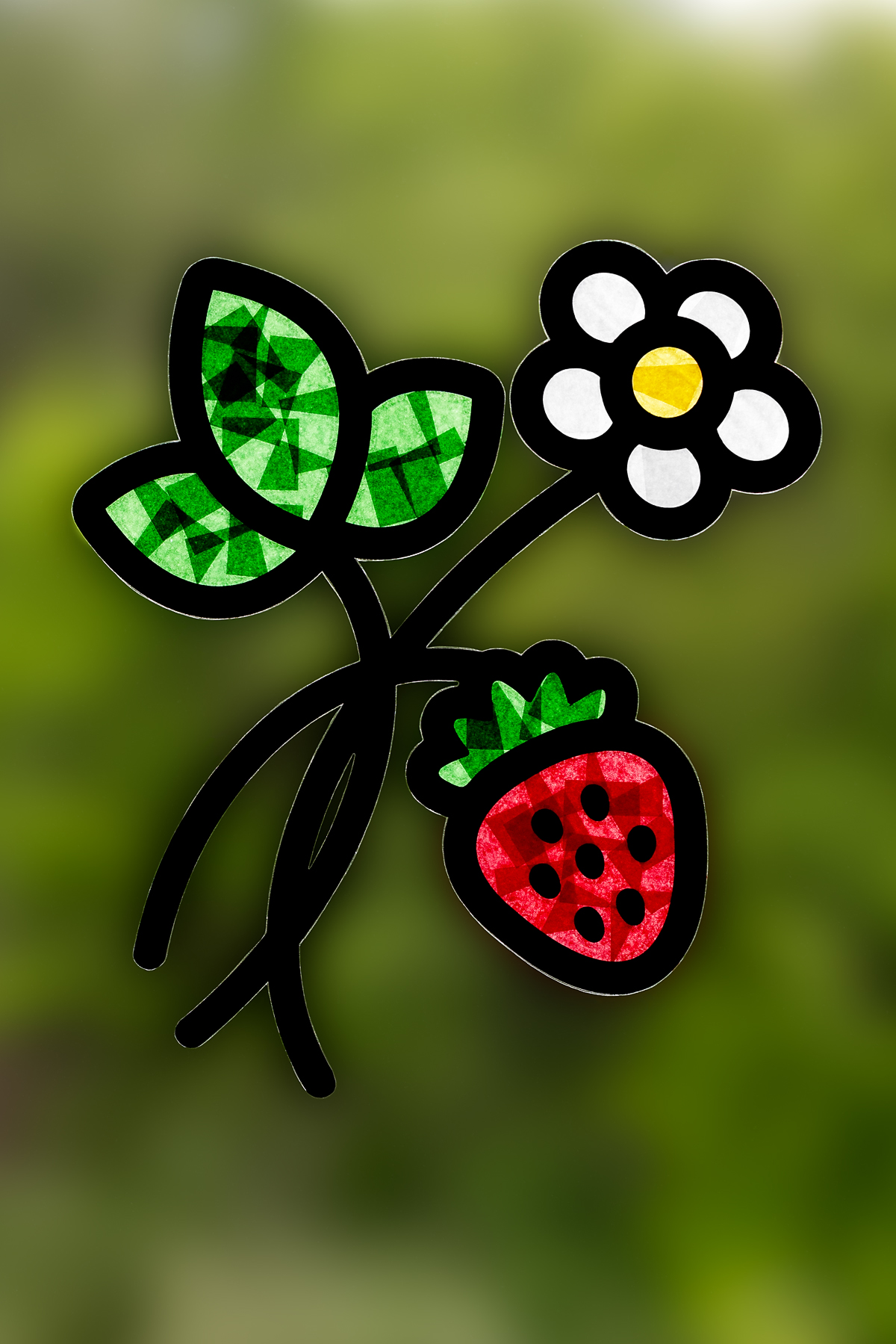 Finished Strawberry Suncatcher hanging on a window.
