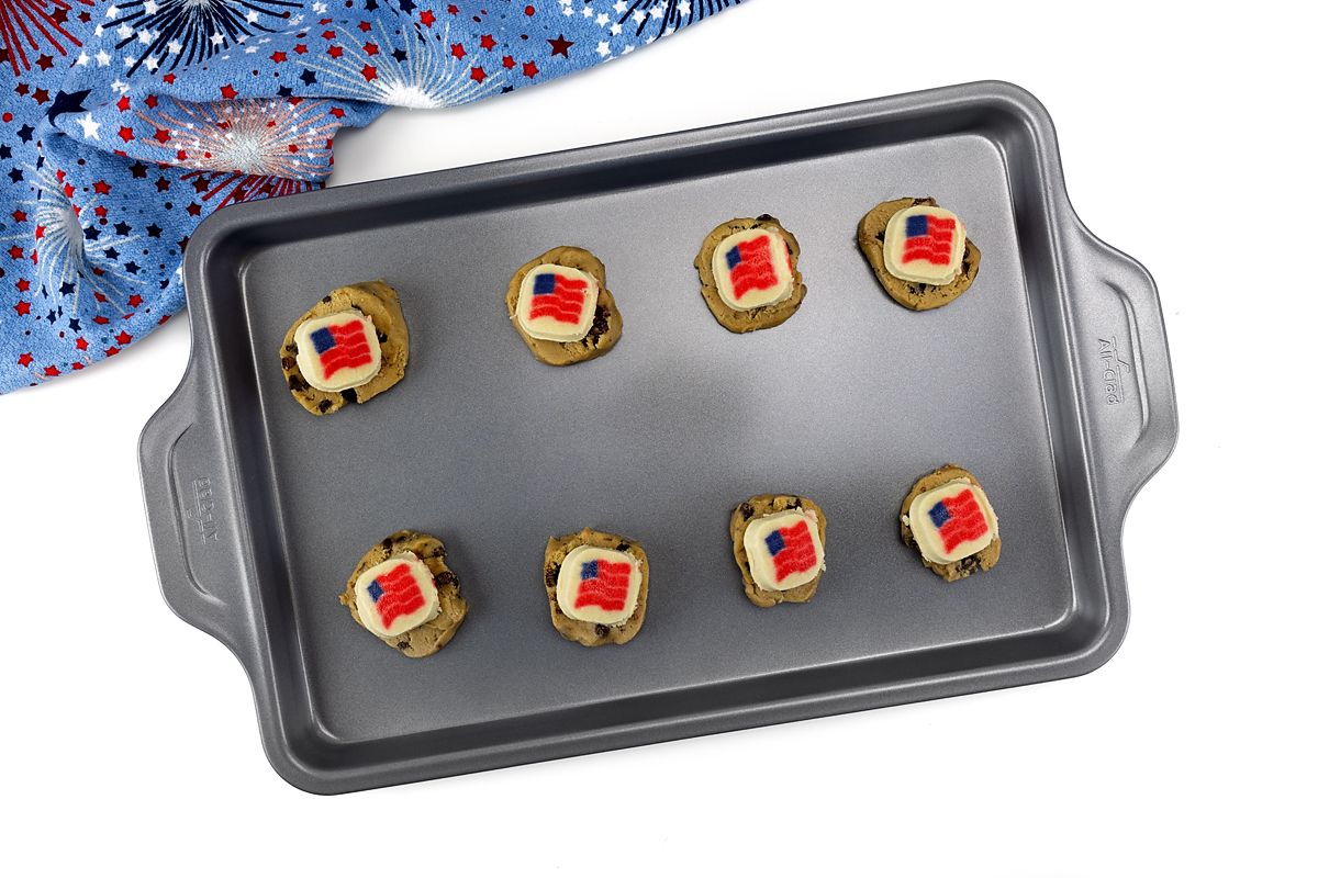 Chocolate chip cookie dough with flag sugar cookies on top.