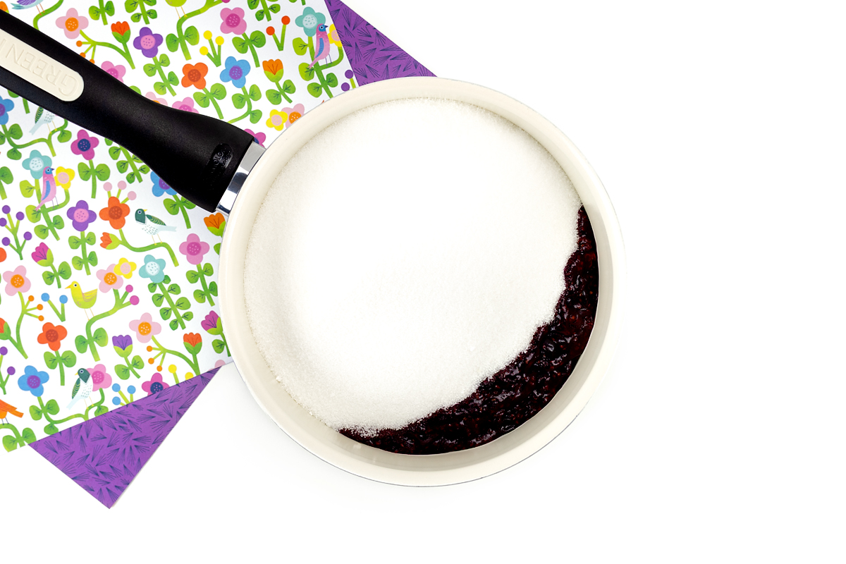 Sugar on cooked blackcurrants.