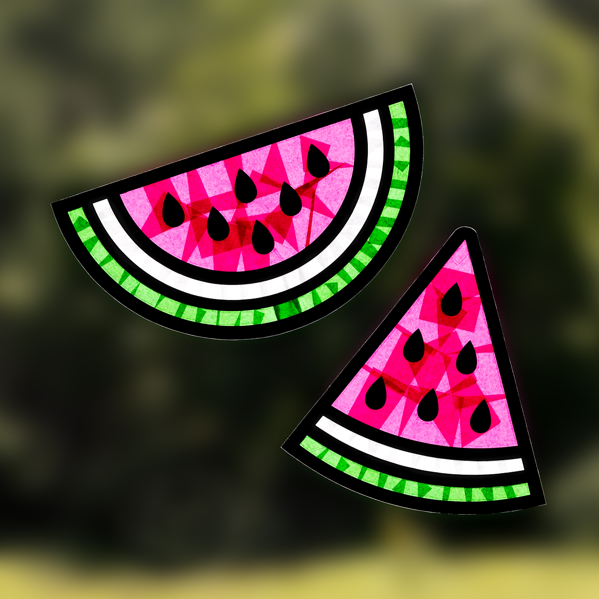 Watermelon suncatchers hanging on a window.
