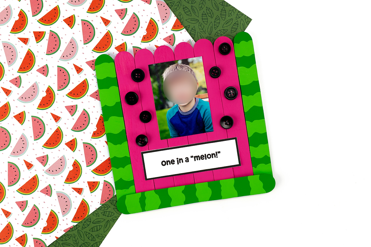 Finished Popsicle Stick Watermelon craft on a colorful background.