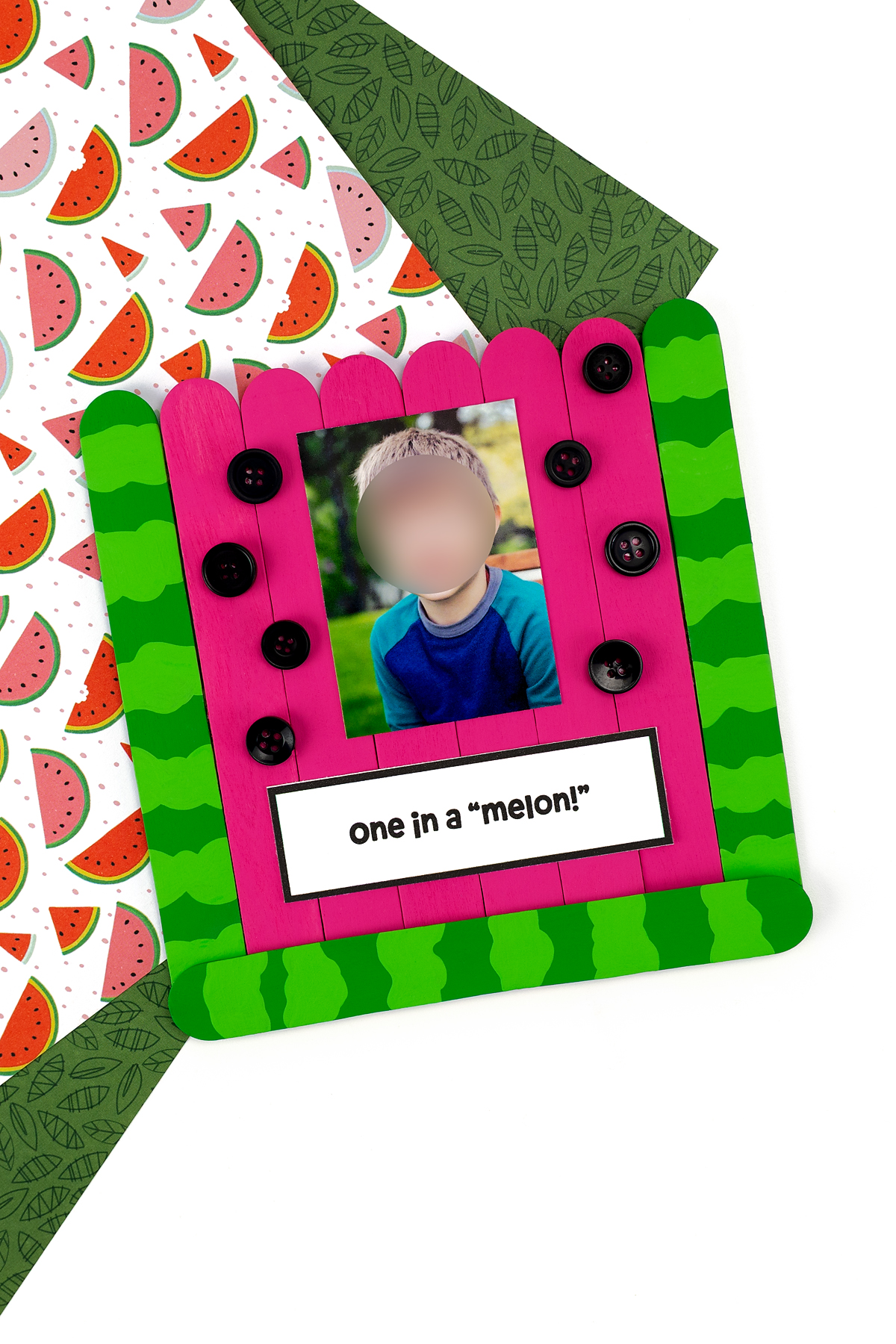 One finished Popsicle Stick Watermelon photo craft on a colorful background.