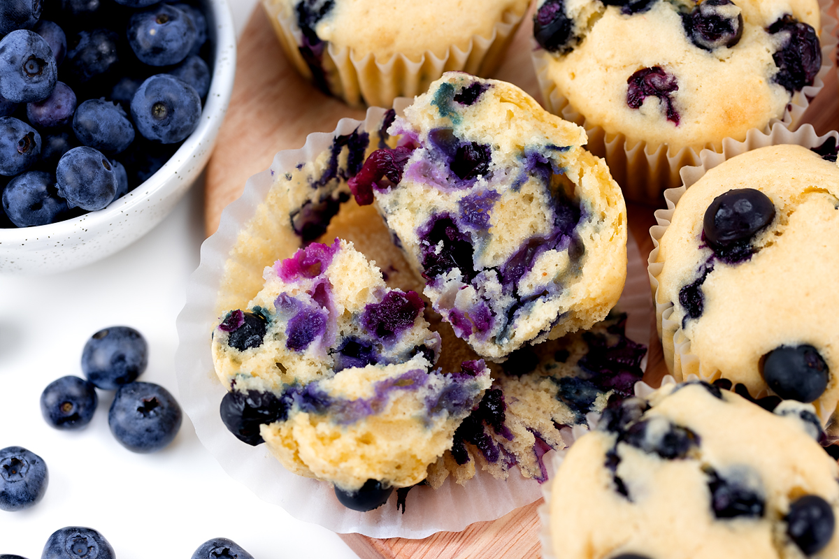 Blueberry muffin torn in half.