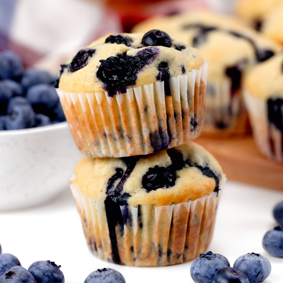 Two stacked blueberry muffins.