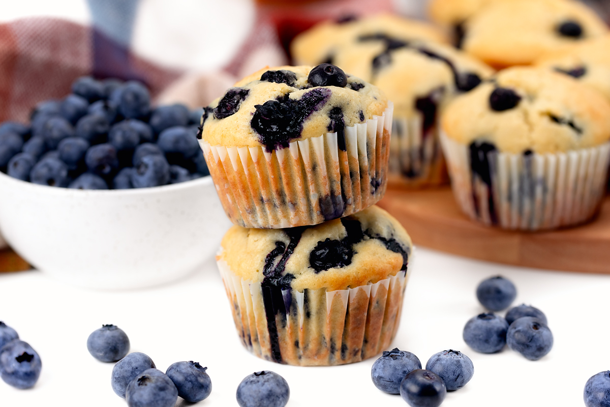 Two stacked blueberry muffins.
