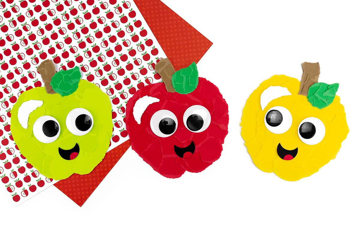Three torn paper apples in a row—green, red, and yellow.