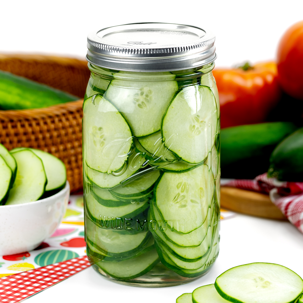 These sweet and sour cucumbers are stored in a quart-sized jar.