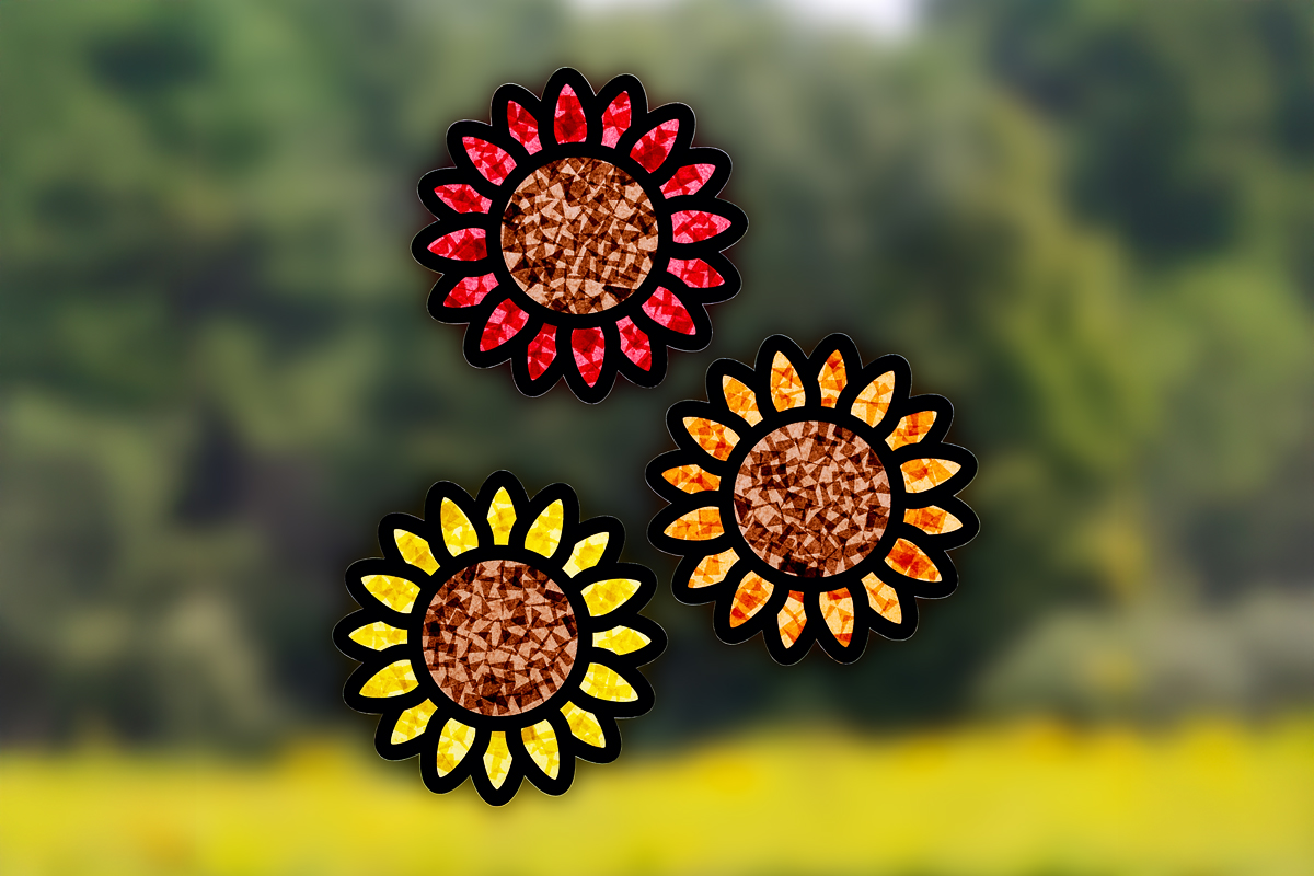 Three sunflower suncatchers in a window.