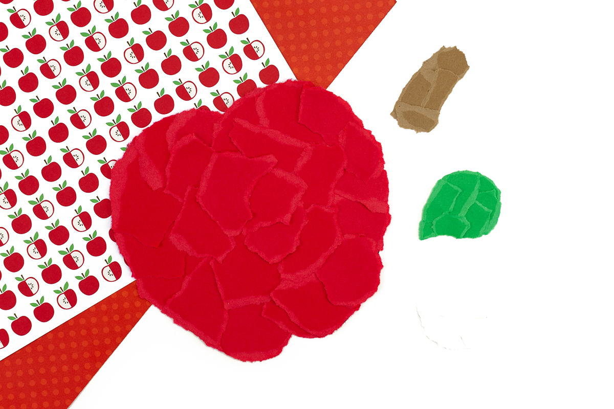 Torn paper apple pieces.