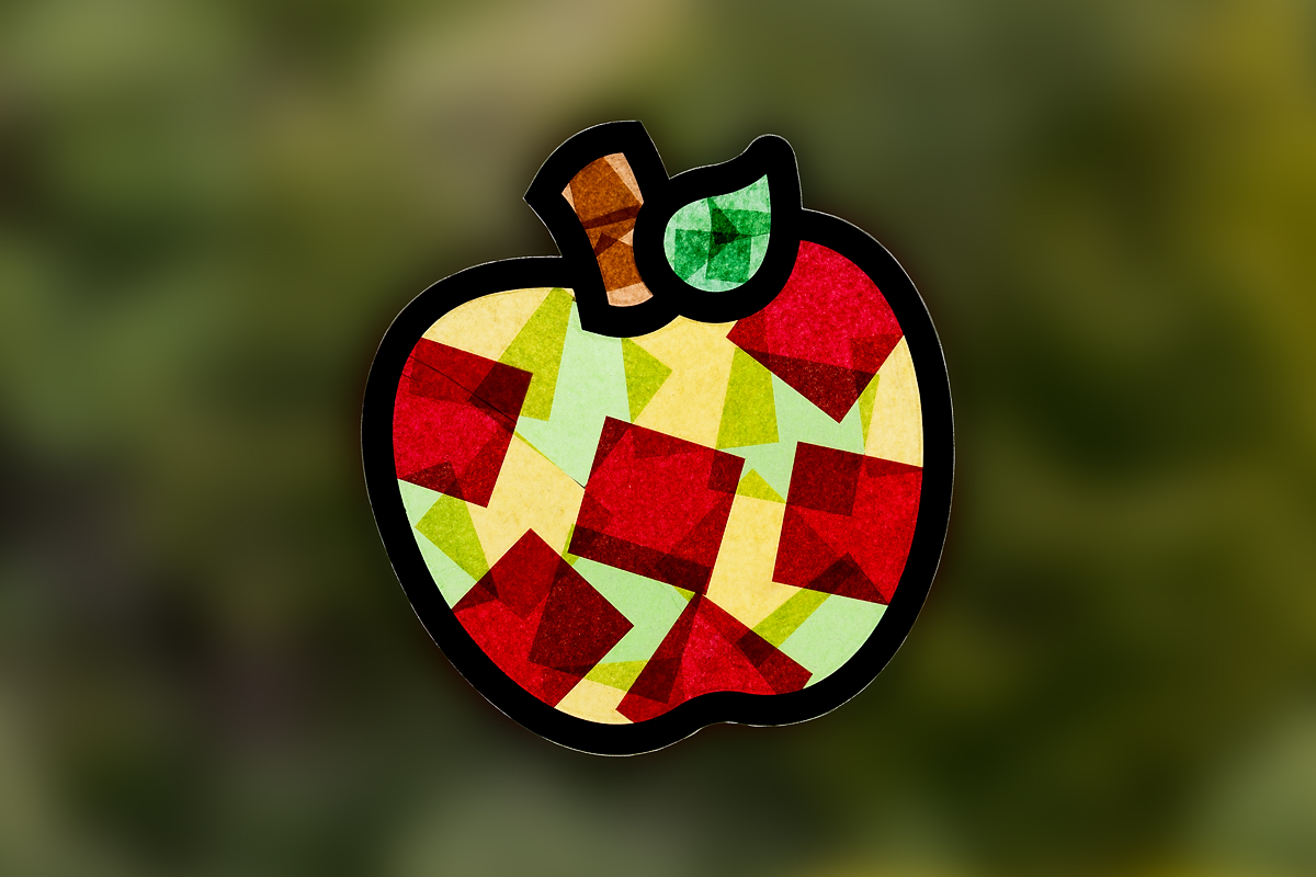 Multi-colored apple suncatcher on a window.